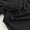 Very soft and warm-touch stretch cotton in black. Lightweight and solid color. High-quality deadstock collected in Stock from a Maison de Couture in Italy.