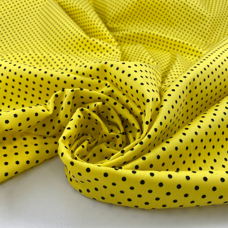 Pure cotton light gabardine with very bright yellow ground and black polka dots design. very soft medium weight. Ideal for dresses, skirts and shirts.High-quality deadstock collected in Stock from a Maison de Couture in Italy.