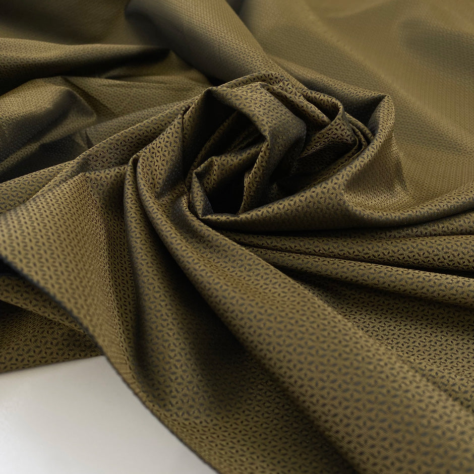 Polyester jacquard in olive green and black. Very soft and light with a very small pattern. High-quality deadstock fabric collected in Stock from a Maison de Couture in Italy.