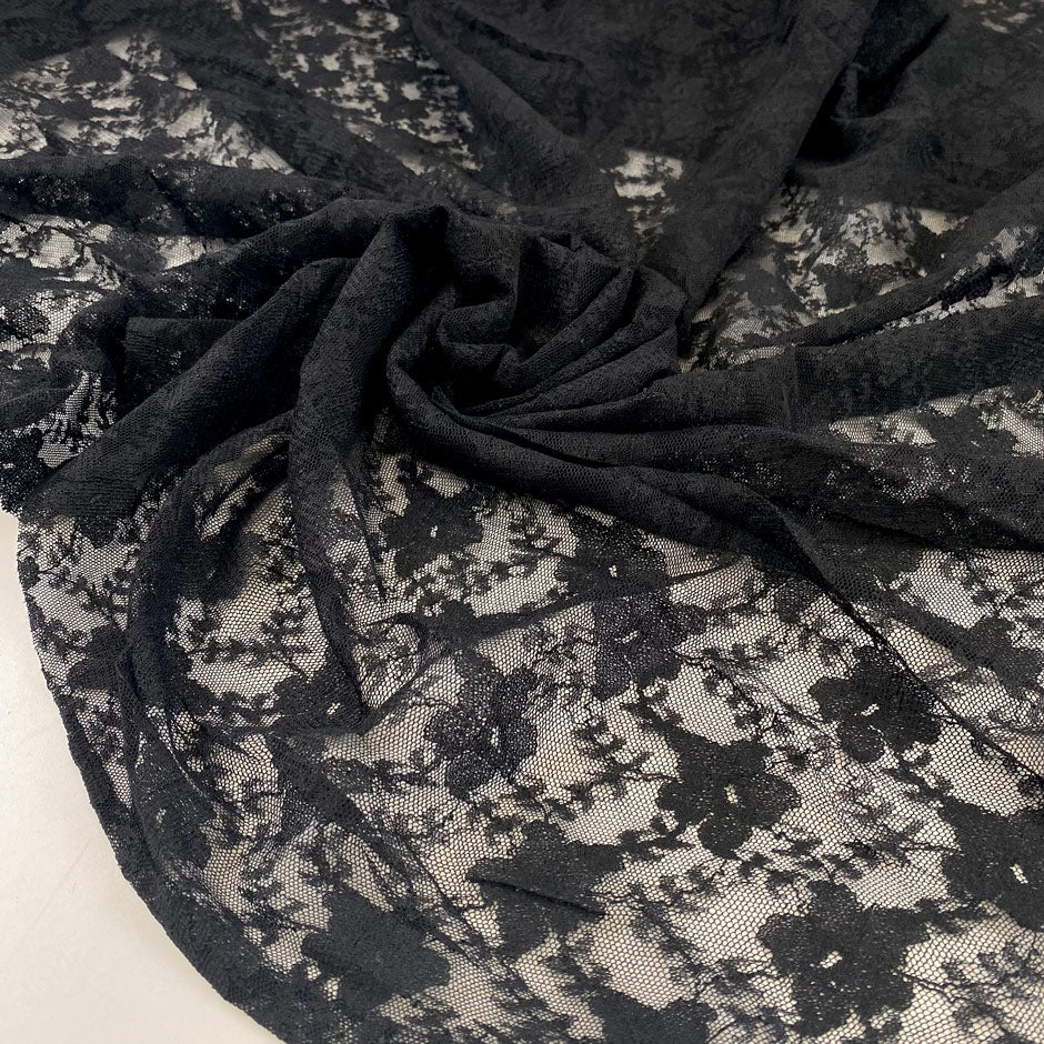 Viscose and polyester stretch light lace in black, flower design. High-quality deadstock fabric collected in Stock from a Maison de Couture in Italy.