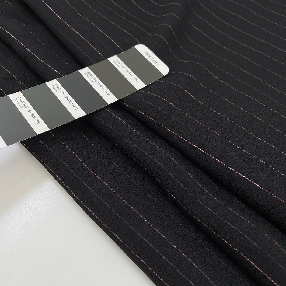 Pure viscose crepe in black with stripe design in rose lurex, very soft, flowy and not transparent. High-quality deadstock fabric by the meter collected in Stock from a Maison de Couture in Italy.