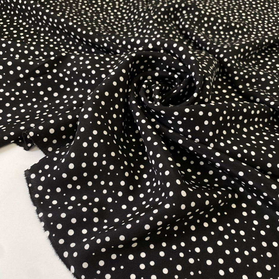 Pure silk crêpe de chine, very soft and light, with a black and white polka dot print. Not transparent and very flowy. Ideal for shirting, dresses, and skirts. High-quality deadstock collected in Stock from a Maison de Couture in Italy.