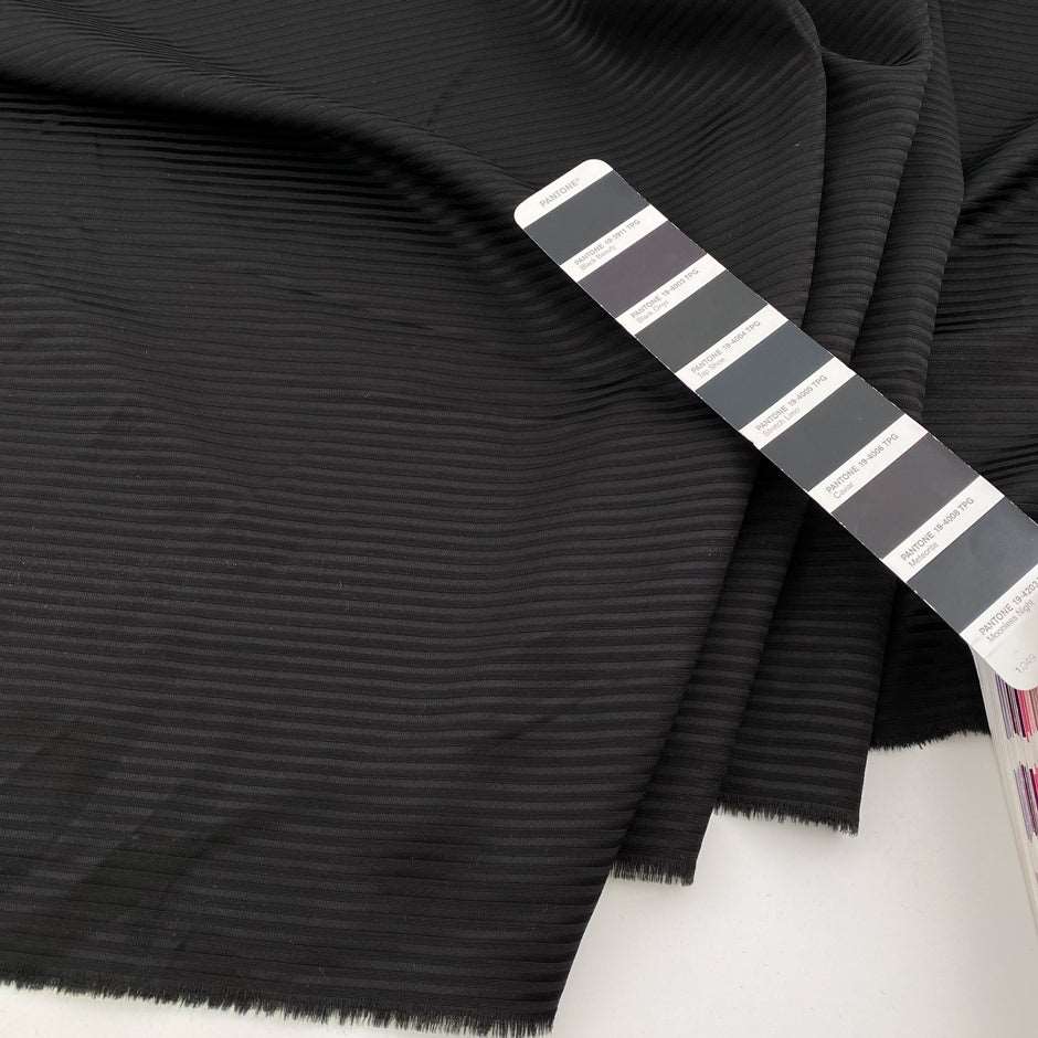 Jacquard stripe of wool-polyester blend, soft and falling black color. High quality deadstock fabric collected in Stock from a Maison de Couture in Italy.