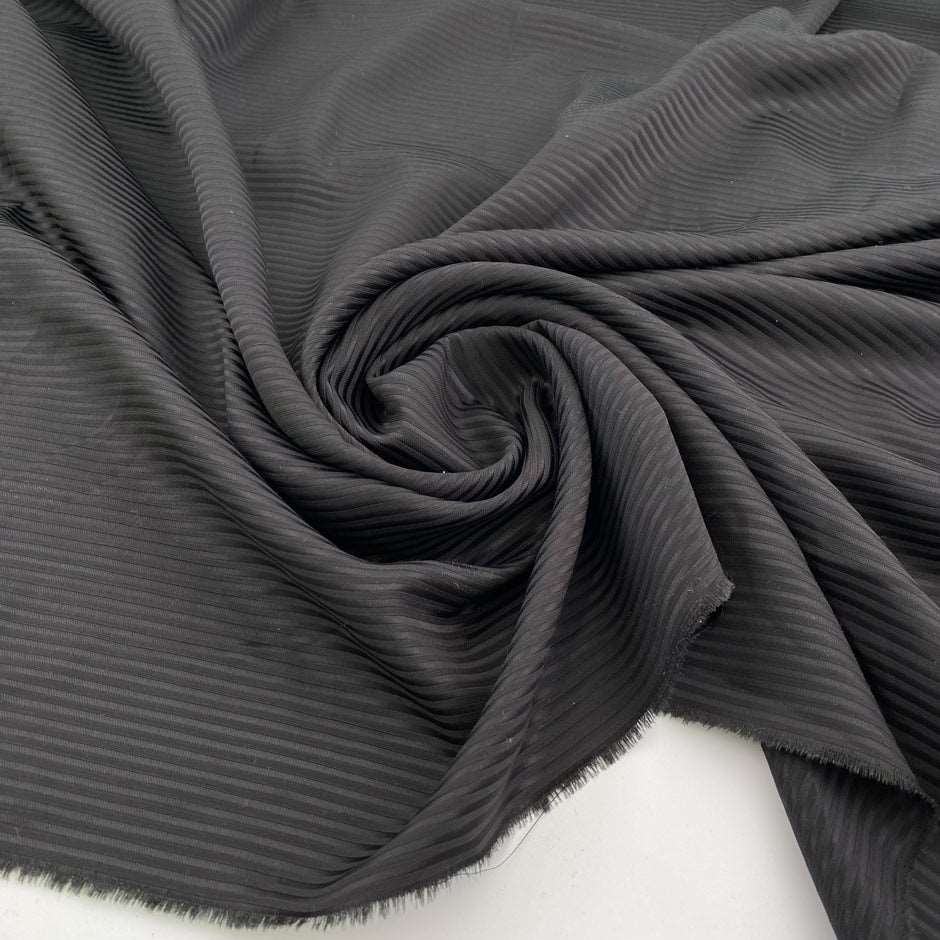 Jacquard stripe of wool-polyester blend, soft and falling black color. High quality deadstock fabric collected in Stock from a Maison de Couture in Italy.