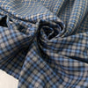 Mixed wool, silk, and cotton with a small check design in the shades of light blue and gray, color reference Blue Jasper. Very soft, medium weight, and flowy. Ideal for trousers, skirts, and jackets. High-quality deadstock collected in Stock from a Maison de Couture in Italy.