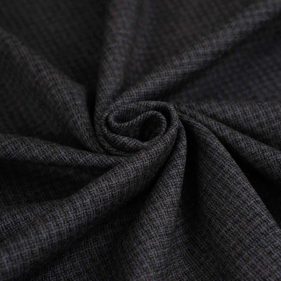 Milan stitch of dark grey cotton and wool. The fabric is droopy and stretchy. High-quality deadstock fabric collected in Stock from a Maison de Couture in Italy.