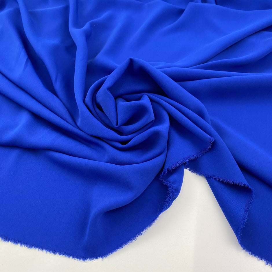 Soft, droopy polyester cady in electric blue. Picked up in Stock from a Maison de Couture in Italy. High quality deadstock fabric.