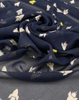 Pure silk chiffon, the ground is dark blue printed with rockets in white and bright yellow. The fabric is very soft and transparent. High-quality deadstock fabric collected in Stock from a Maison de Couture in Italy.