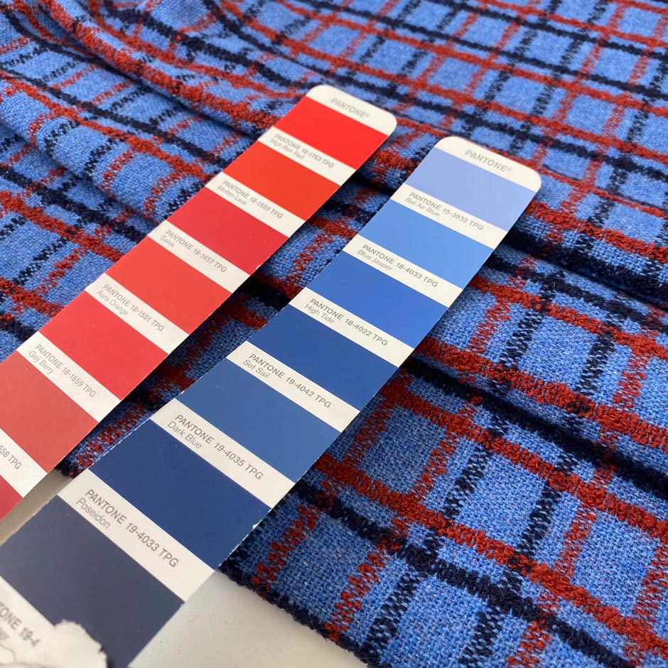 Pure wool twill with check pattern in blue red and dark blue shades blue jasper and molten lava soft and warm ideal for jackets light coats and winter skirts. High-quality deadstock collected in Stock from a Maison de Couture in Italy.