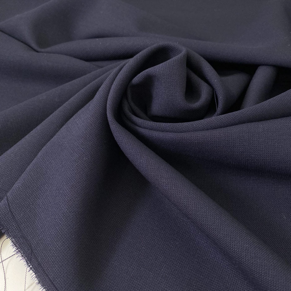 Soft and flowy virgin wool with elastane in dark blue. Not transparent and ideal for dresses, skirts, trousers, and jackets.
High-quality deadstock collected in Stock from a Maison de Couture in Italy.