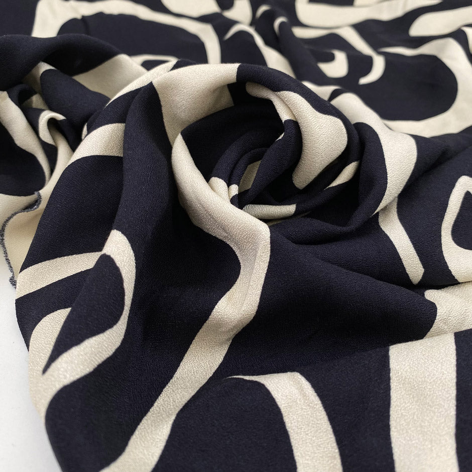 Pure viscose crepe in dark blue and beige shades, with a very big geometrical design. Very soft and light. High-quality deadstock fabric by the meter collected in Stock from a Maison de Couture in Italy.