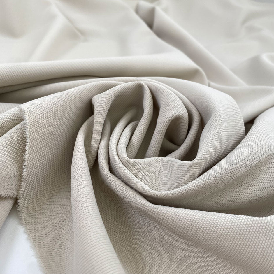 Polyester and elastane cady very light, beige soft and flowy, not transparent and textured. High-quality deadstock fabric collected in Stock from a Maison de Couture in Italy.