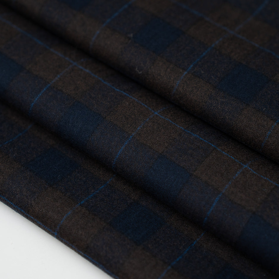 Lightweight blue and brown checked flannel pure virgin wool. High-quality deadstock fabric collected in Stock from a Maison de Couture in Italy.