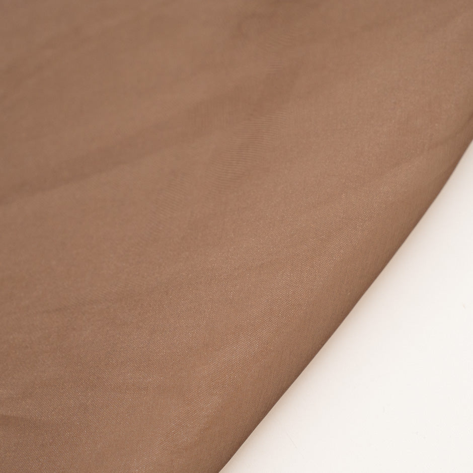 Very light and soft brown polyester organza. High-quality deadstock fabric collected in Stock from a Maison de Couture in Italy.