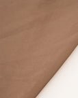 Very light and soft brown polyester organza. High-quality deadstock fabric collected in Stock from a Maison de Couture in Italy.