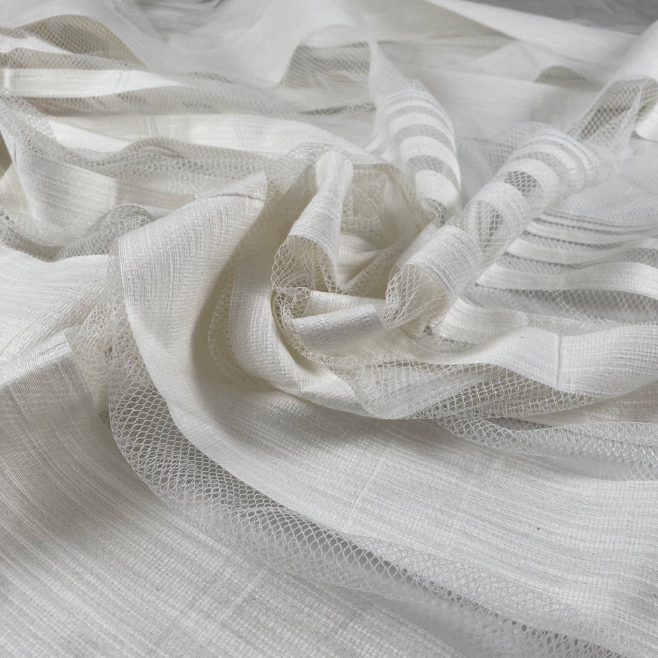 Jacquard net in cotton and polyester with striped design, in star white color. Very light and soft, transparent. Ideal for dresses, skirts, shirting, and blouses. High-quality deadstock collected in Stock from a Maison de Couture in Italy.