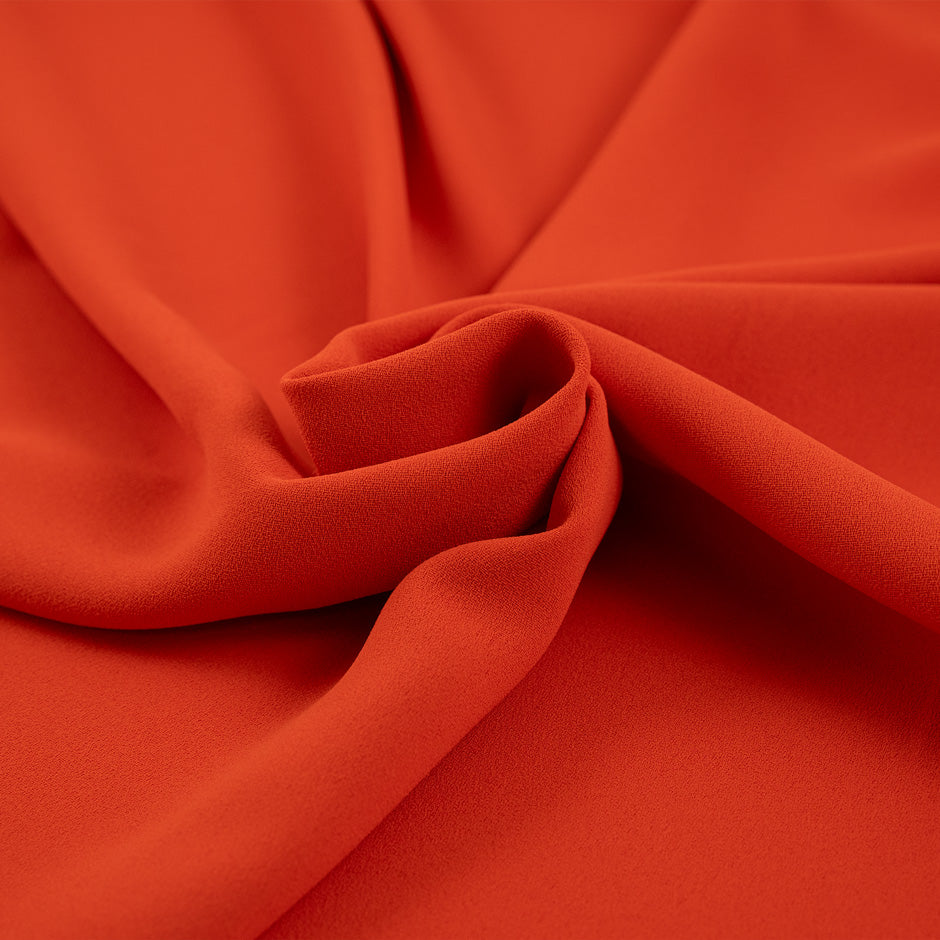 Orange and falling polyester cady crepe. High quality deadstock fabric.