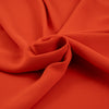 Orange and falling polyester cady crepe. High quality deadstock fabric.