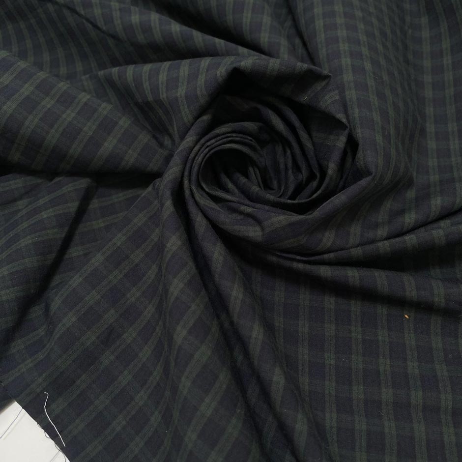 Soft pure cotton poplin with a check pattern in green and dark blue. Comfortable and versatile, ideal for shirting and dresses.High-quality deadstock collected in Stock from a Maison de Couture in Italy.