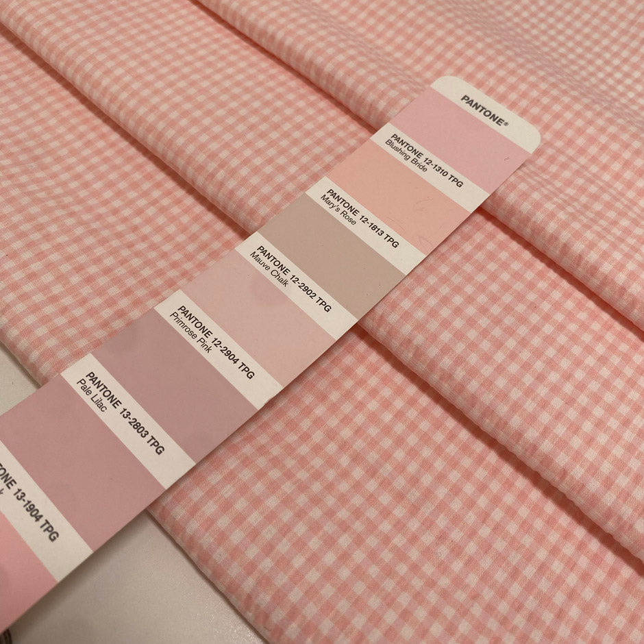 Cotton and polyester blend with stretch in a white and pink checked seersucker texture. Soft and fresh, ideal for dresses, skirts, trousers, and blouses.High-quality deadstock collected in Stock from a Maison de Couture in Italy.