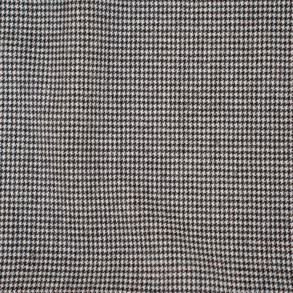 Square pattern in black and white wool and nylon fabric. It is stretch and falling. High-quality deadstock fabric collected in Stock from a Maison de Couture in Italy.