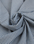 Virgin wool and viscose stretch fabric in white and blue checks. High quality deadstock fabric.
