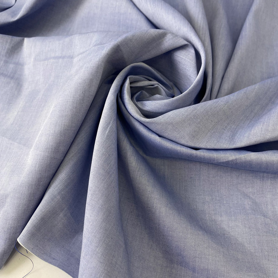 Pure cotton poplin in light blue color reference Eventide. Very soft and light, ideal for shirting, dresses and skirts. High-quality deadstock collected in Stock from a Maison de Couture in Italy.