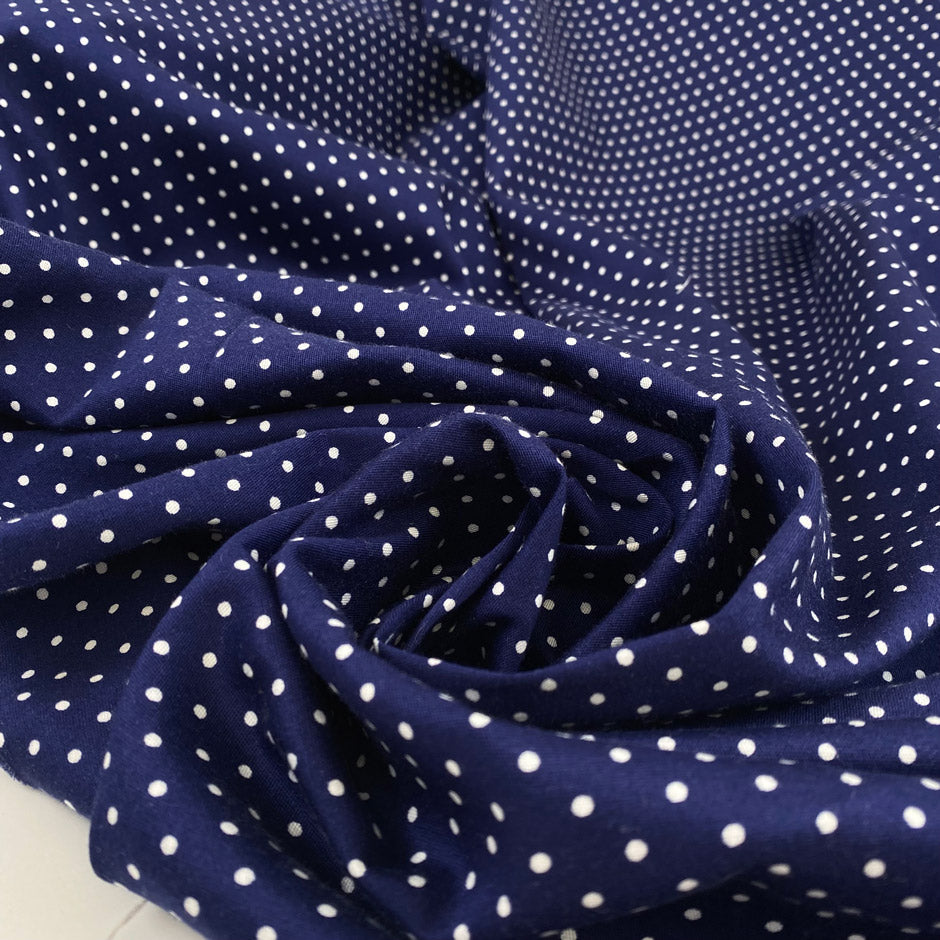 Pure cotton stretch fabric with a blue base and white polka dot design, very soft, medium weight, and not transparent. Ideal for shirts, dresses, and skirts. High-quality deadstock collected in Stock from a Maison de Couture in Italy.