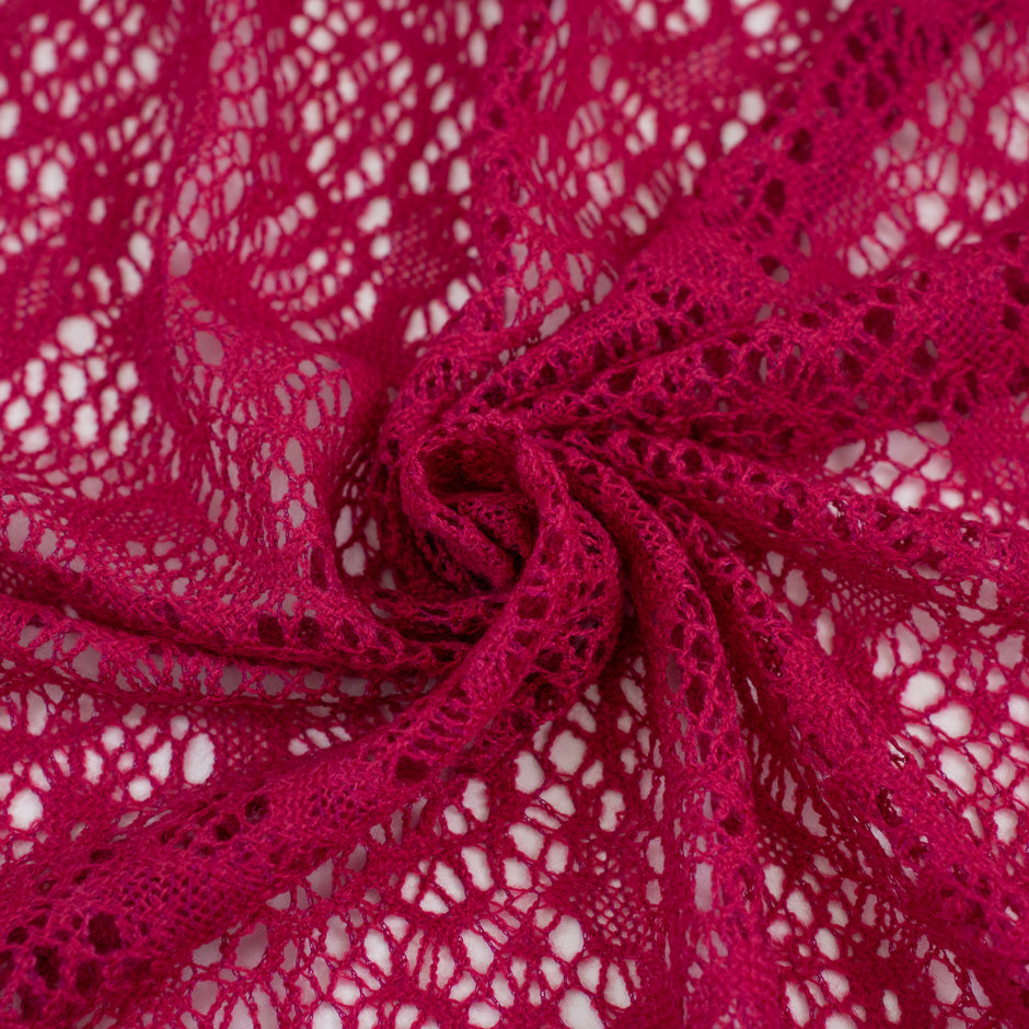 Fucsia lace wool and polyester with a geometric pattern. The fabric is stretch and falling. High-quality deadstock fabric collected in Stock from a Maison de Couture in Italy.