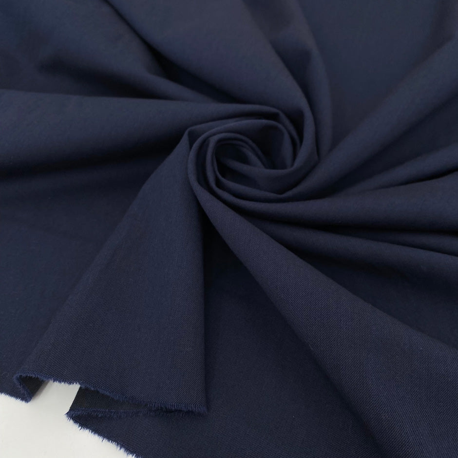 Mixed wool and linen stretch gabardine in dark blue color reference Outer Space. Very soft and flowy, ideal for trousers, skirts, jackets, and dresses. High-quality deadstock collected in Stock from a Maison de Couture in Italy.