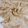 Polyester lace in floral design stretch, very soft and light. Skin ground color with some gold lurex. High-quality deadstock fabric collected in Stock from a Maison de Couture in Italy.