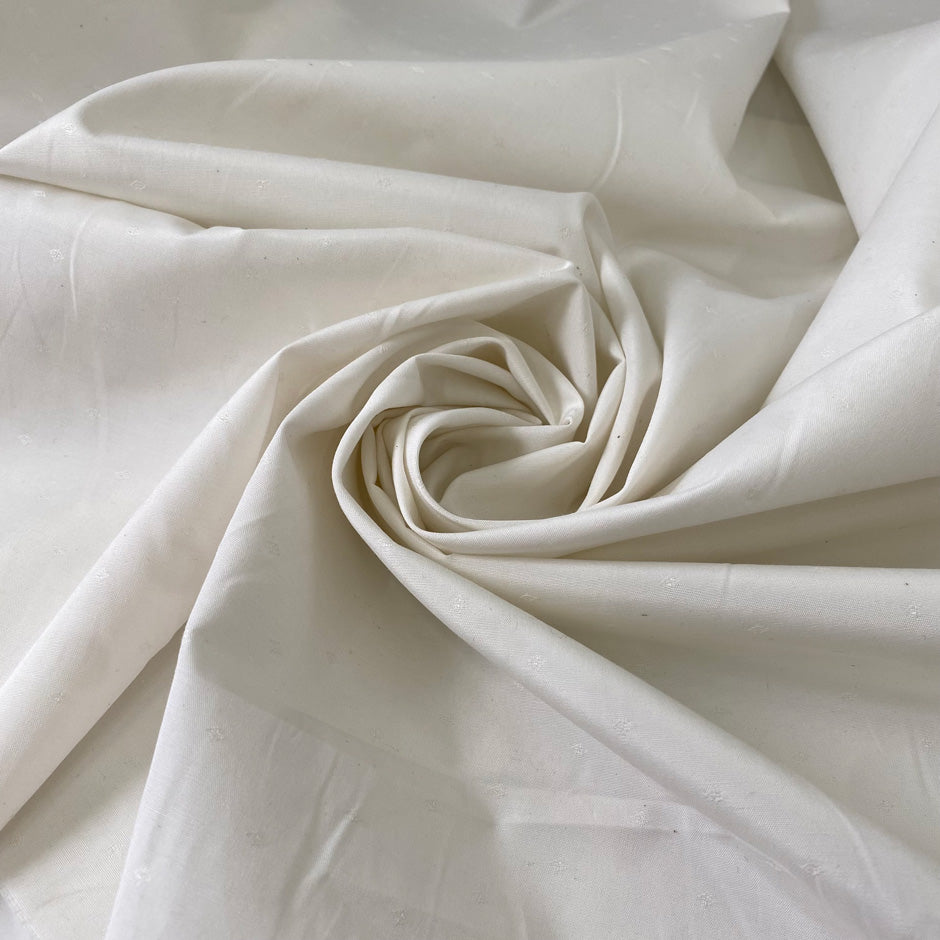 Cotton, polyester and elastane blend in white Marshmallow. Soft, not transparent, with a subtle micro texture. Ideal for trousers, dresses and skirts. High-quality deadstock collected in Stock from a Maison de Couture in Italy.