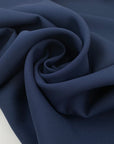 Double acetate and viscose cady in navy blue with a shiny side, it's heavy and stiff. High-quality deadstock fabric collected in Stock from a Maison de Couture in Italy.