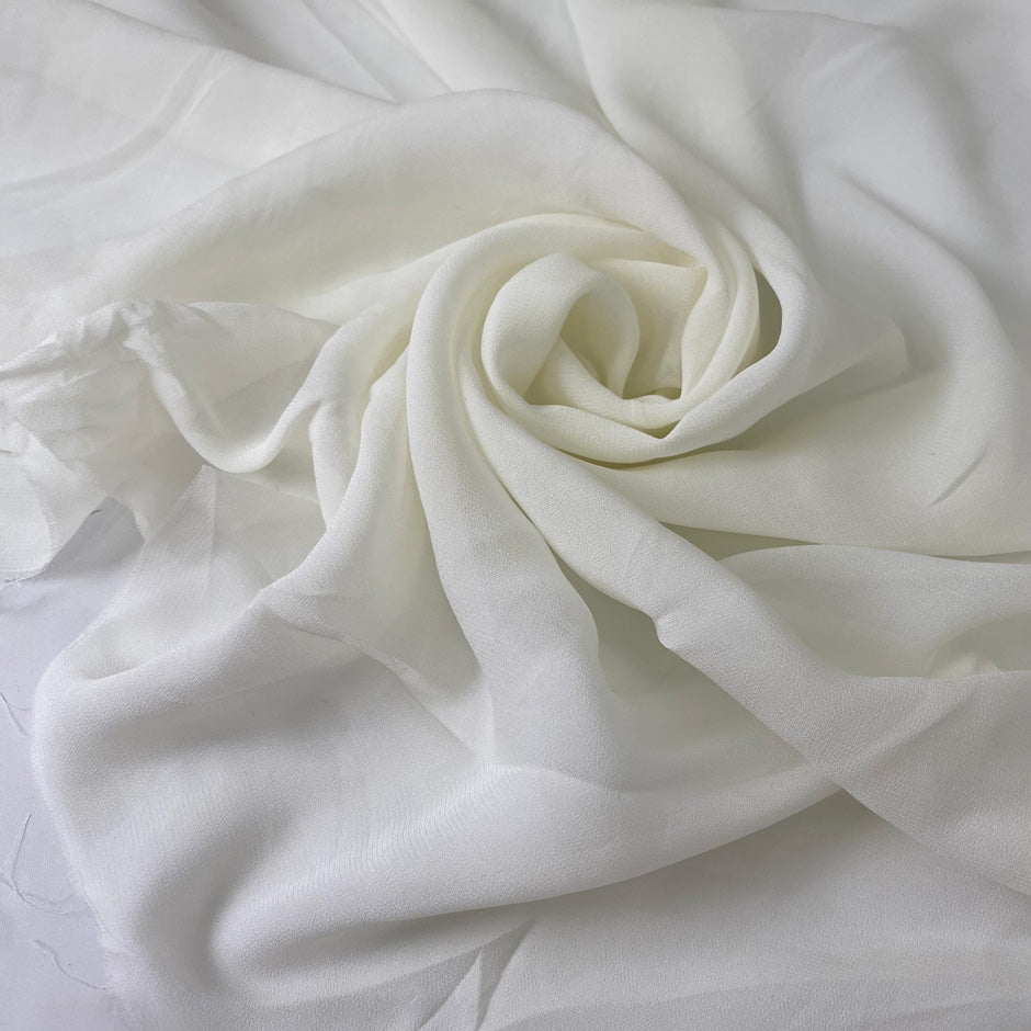 Pure viscose chiffon in white, color reference Marshmallow. Very soft and light, transparent and flowy. Ideal for dresses, skirts, blouses, and shirting. High-quality deadstock collected in Stock from a Maison de Couture in Italy.
