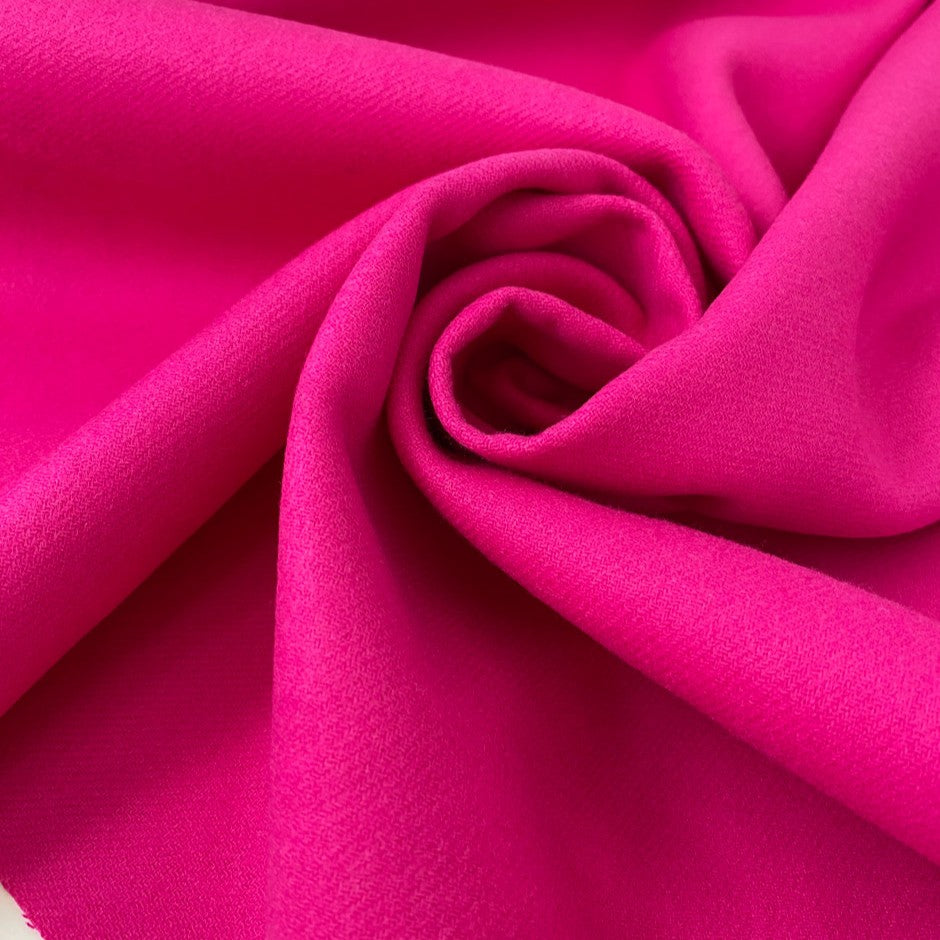 Soft and warm wool and polyester coating in vibrant fuchsia. Perfect for creating stylish coats and jackets.High-quality deadstock collected in Stock from a Maison de Couture in Italy.