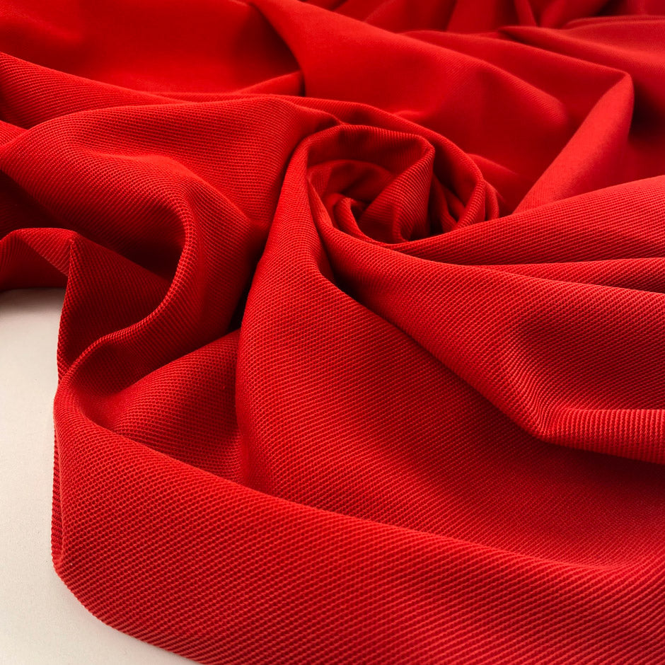Red heavy cotton jersey with a textured surface, slight stretch, and soft, flowy drape. High-quality deadstock collected in Stock from a Maison de Couture in Italy.