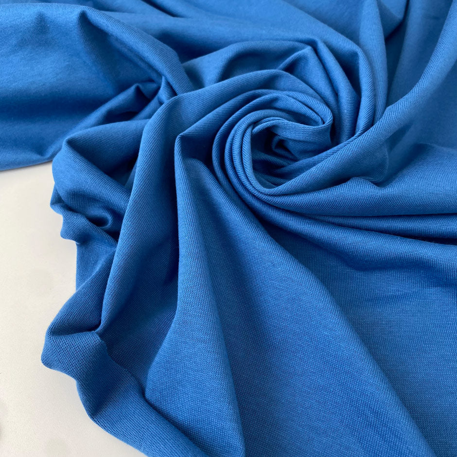Cotton jersey in light blue color reference Leaching Blue. Very soft, flowy, and light. Ideal for t-shirts, dresses, light trousers, sweatshirts, and skirts. High-quality deadstock collected in Stock from a Maison de Couture in Italy.