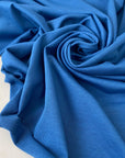 Cotton jersey in light blue color reference Leaching Blue. Very soft, flowy, and light. Ideal for t-shirts, dresses, light trousers, sweatshirts, and skirts. High-quality deadstock collected in Stock from a Maison de Couture in Italy.