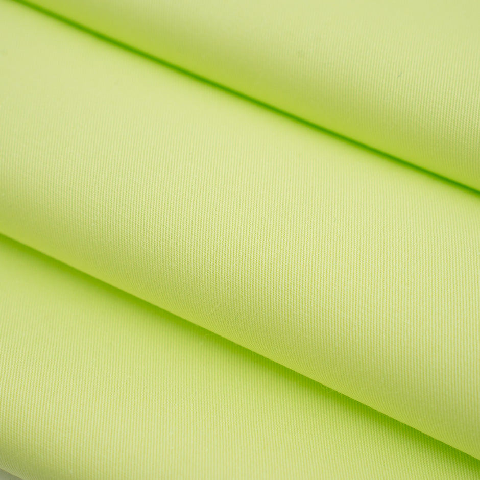 Textured fabric of pure bright green cotton. High-quality deadstock fabric collected in Stock from a Maison de Couture in Italy.