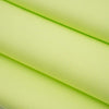 Textured fabric of pure bright green cotton. High-quality deadstock fabric collected in Stock from a Maison de Couture in Italy.