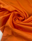 Pure cotton batiste in orange color reference Autumn Sunset. Very light and soft, not transparent. Ideal for summer dresses, skirts, blouses, and shirting. High-quality deadstock collected in Stock from a Maison de Couture in Italy.
