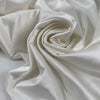 Cotton and viscose white satin, color reference snow white. Very shiny, stretch, and soft. Ideal for dresses, bridal, skirts, trousers, and jackets. High-quality deadstock collected in Stock from a Maison de Couture in Italy.