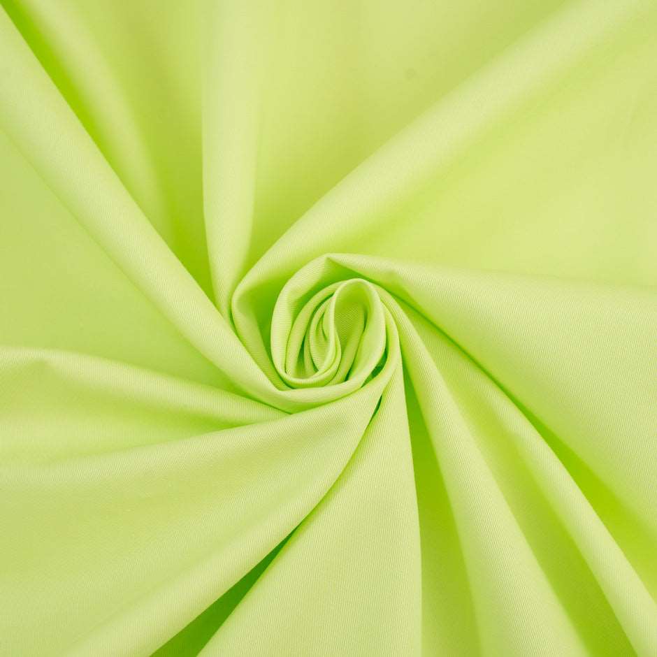 Textured fabric of pure bright green cotton. High-quality deadstock fabric collected in Stock from a Maison de Couture in Italy.