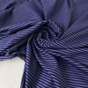 Striped cotton jersey in purple and black, soft and light with a natural stretch. Perfect for t-shirts, dresses, trousers, and skirts. High-quality deadstock collected in Stock from a Maison de Couture in Italy.