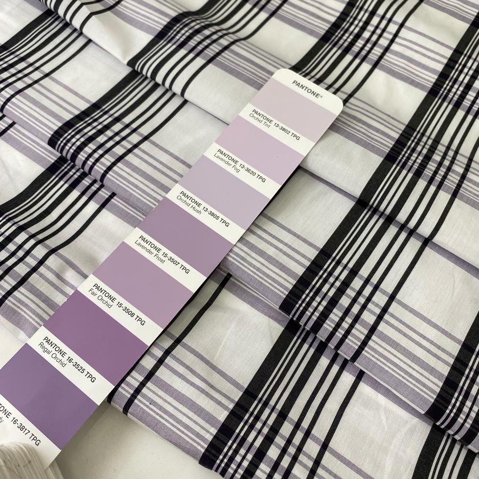 Checked fabric in a wool and cotton blend with a taffeta-like texture that keeps its shape and adds volume. In shades of white, black, and lilac. Ideal for dresses, skirts, and shirting. High-quality deadstock collected in Stock from a Maison de Couture in Italy.