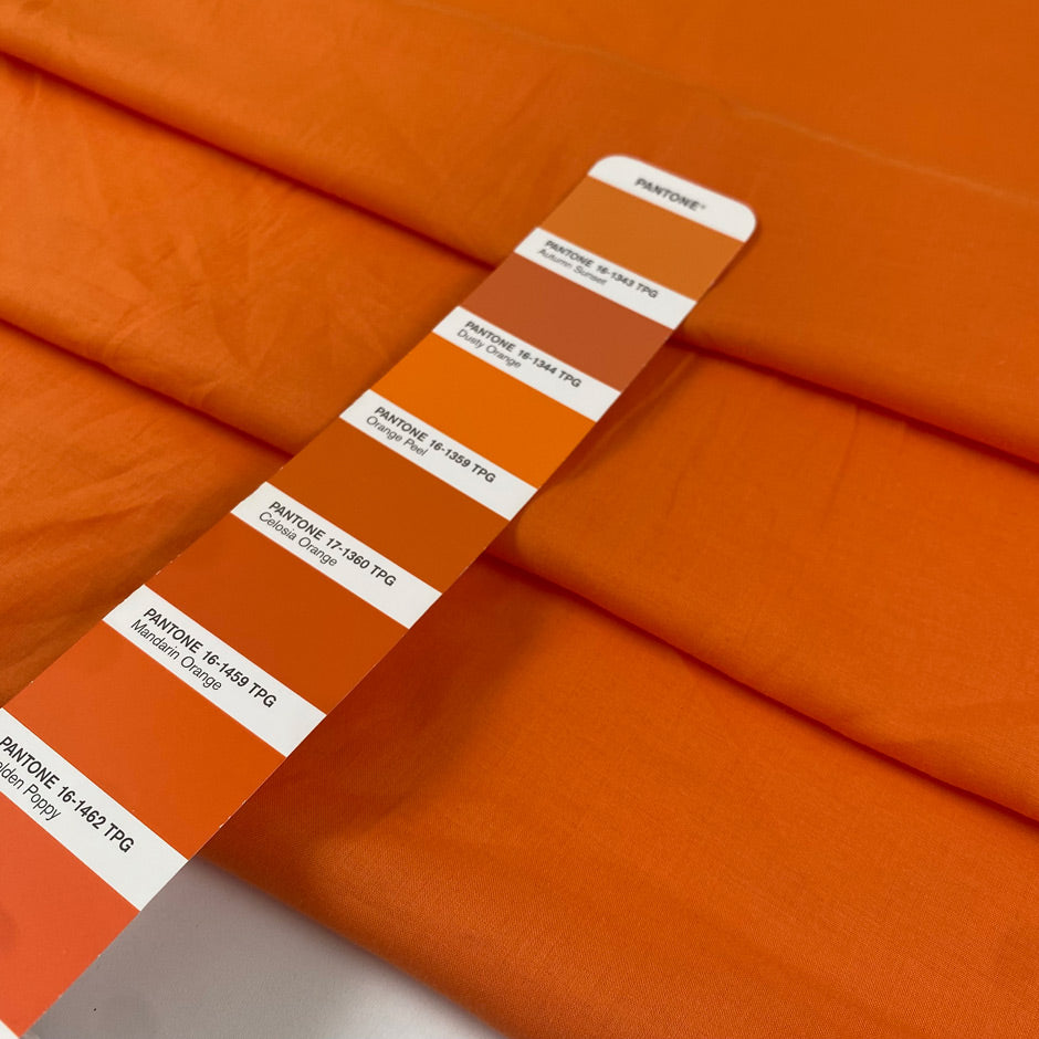 Pure cotton batiste in orange color reference Autumn Sunset. Very light and soft, not transparent. Ideal for summer dresses, skirts, blouses, and shirting. High-quality deadstock collected in Stock from a Maison de Couture in Italy.