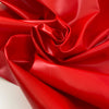 Vinyl fabric in flame red, very stiff in cotton and polyester. High-quality deadstock fabric by the meter collected in Stock from a Maison de Couture in Italy.