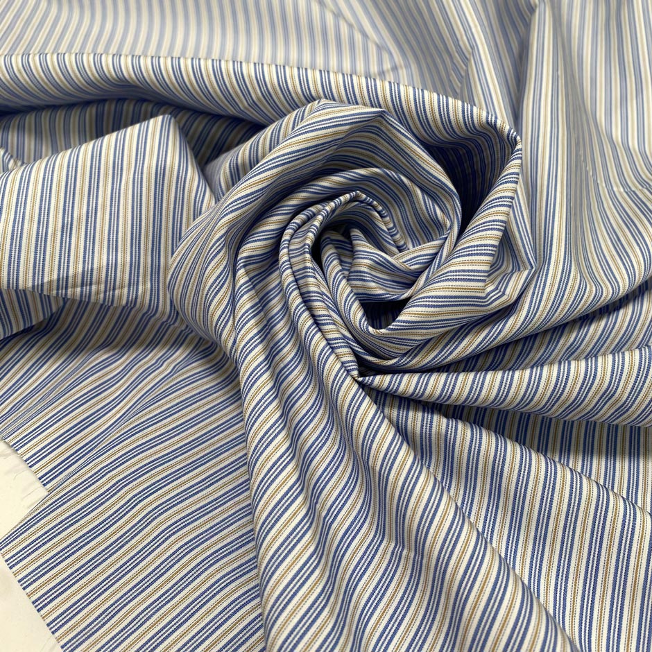 Soft and lightweight pure cotton poplin with stripes in light blue, white, and ochre. Not transparent, perfect for shirting and dresses.High-quality deadstock collected in Stock from a Maison de Couture in Italy.