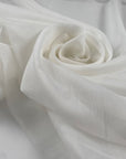 Pure cotton gauze in coconut milk white, very soft, light, and transparent. Flowy and breathable, ideal for dresses, shirting, and blouses. High-quality deadstock collected in Stock from a Maison de Couture in Italy.