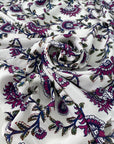 Pure silk crêpe de chine with a white ground and floral design in the shades of festival fuchsia, blue, and green. Very soft and flowy, not transparent. Ideal for dresses, skirts, blouses, and shirting. High-quality deadstock collected in Stock from a Maison de Couture in Italy.